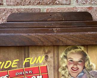 A67 - $550. Dr Pepper “Fireside Fun” cardboard sign with wood frame. Measures 26.5“ x 22“.