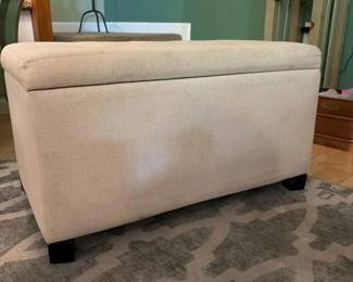066 beigeupholsteredstorageottomanincon