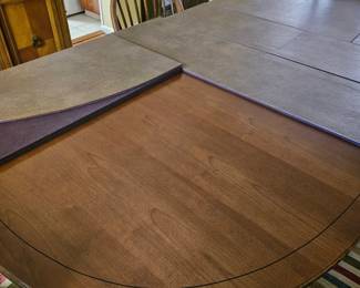 Dining room table with protective pad
