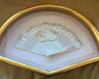 Antique miniature Brise fan of carved intricately carved bone sticks. Woman with sheep in center. Gilt embellishments. Note damage on one stick
