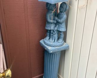 . . . two girls under umbrella on pedestal