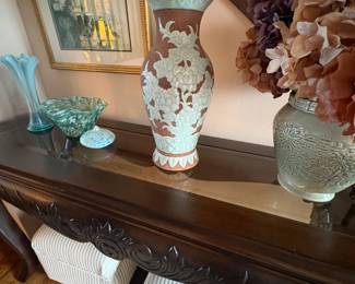 . . . an assortment of pottery and art glass on sofa table