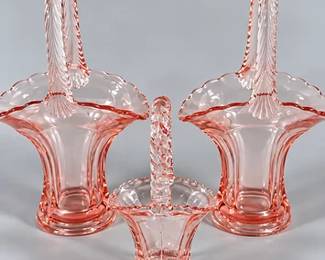 Vintage pink glass baskets, multiples of clear, purple, red and uranium glass baskets also in auction