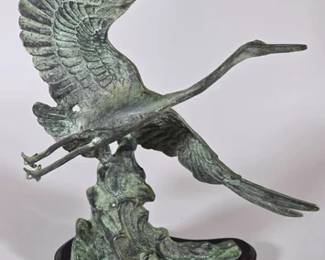 Toyo cast bronze sculpture of a crane or heron in flight taking off from stylized waves
