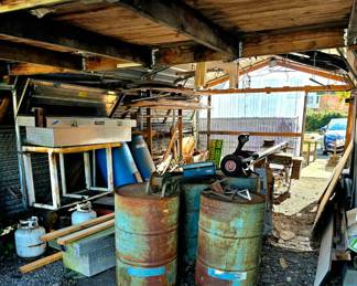 empty metal and plastic barrels, metal truck boxes and misc shed items