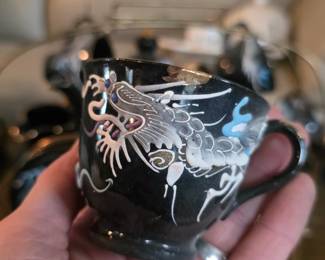 ... with raised hand-painted dragon motifs