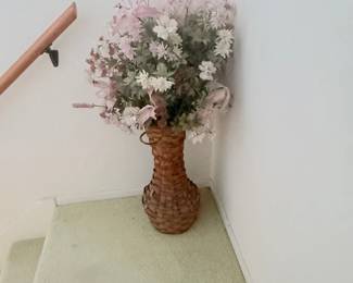 Silk flower arrangement in basket vase