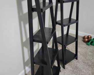 2 Black Tiered Shelves, 53” Tall and 17” wide, 14” deep at base.