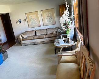 Couch, paintings, vintage decorations.