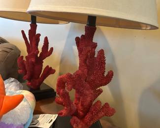This table lamp is the Safavieh Coral Branch Table Lamp in red, which features a detailed, coastal faux-coral sculptural base mounted on a square black foundation.