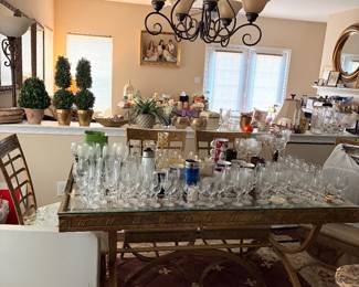 Dinning room table, rug, glassware, plants, mirror, wall decor