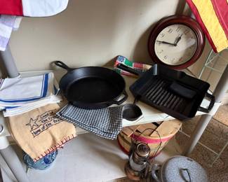 Cast-iron skillets, clock, vintage linens, enamel grain wire pan
