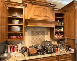 Stainless steel pots and pans, spices, vintage cookbooks