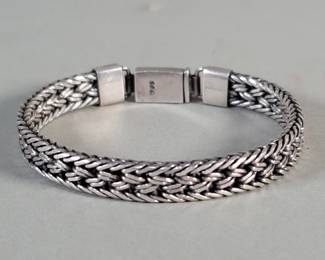 731  Lot 603  Sterling silver woven chain bracelet featuring a