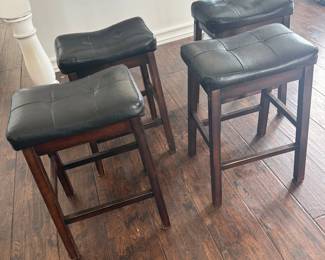 Lot #55- Four Coaster Backless Counter Stools with Black Padded Seats