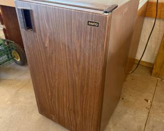 Lot #217- Sanyo Compact Refrigerator with Woodgrain-Style Door