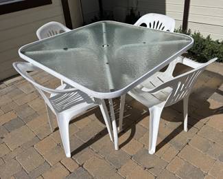 Lot #148- Glass-Top Patio Table & Four White Armchairs