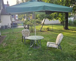 Backyard, table umbrella, two chairs and mosquito netting