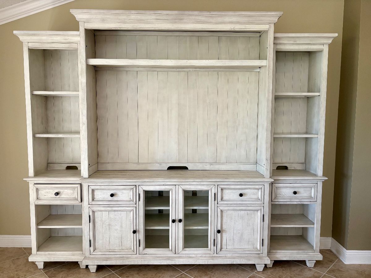 Haverty's Beckley Farmhouse distressed white entertainment wall unit. Fits tv sizes up to 62". Measurements: W - 112" / H - 91" / D - 19"