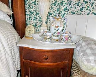 One of two night stands in bedroom set