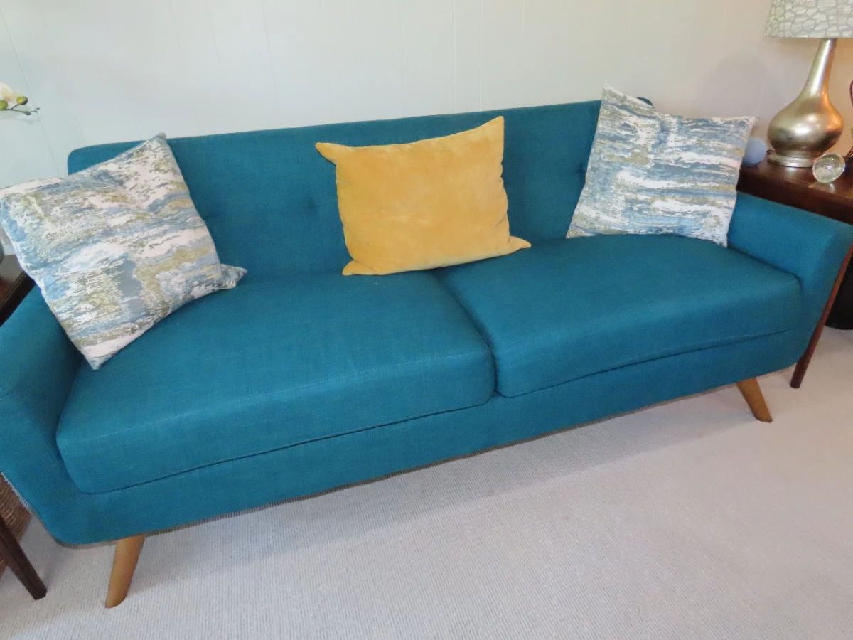 Turquoise/teal colored fabric sofa.