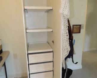 Tall storage cabinet with drawers and shelves.