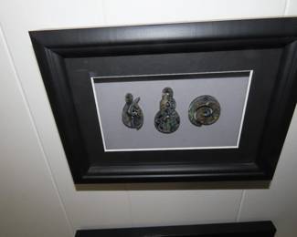 Framed New Zealand Maori tribal tokens.