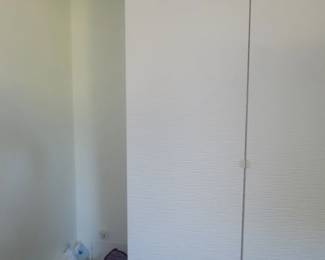 Tall storage cabinet with drawers and shelves.