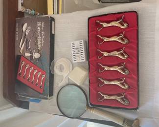 Boxed set of six decorative animal-shaped knife rests in a red-lined case.