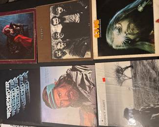 Assorted rock vinyl LPs with illustrated and photographic album jackets.