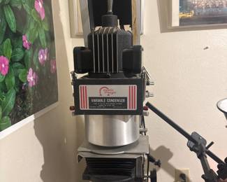 Benchtop workshop machine with motor and adjustable lever controls.