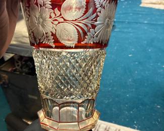 Decorative glass vase with red floral pattern and textured clear glass.