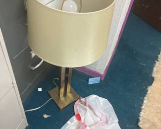 Table lamp with a light-colored cylindrical shade.