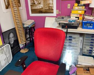 Red upholstered office chair with armrests.