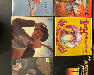 Assorted vinyl records with illustrated album sleeves.