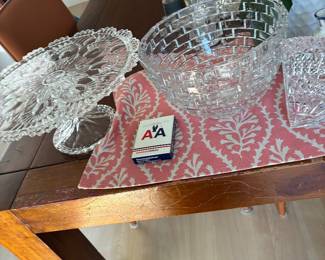 Clear cut-glass serving bowls with decorative scalloped edges.