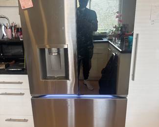 Stainless-steel French-door refrigerator with bottom freezer drawer.