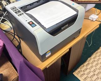 Desktop printer on a wooden table.