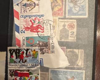 Stamp collection displayed in an album with assorted international postage stamps.