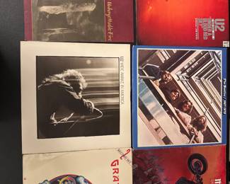 Vinyl record collection including Grateful Dead, Genesis, and Jethro Tull albums; assorted classic rock LPs with original cover art.