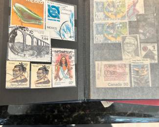 Open stamp album displaying assorted international postage stamps.