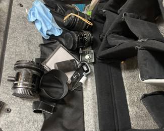 Camera bodies, lenses, bags, and photographic accessories.