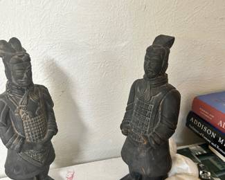 Pair of decorative warrior figurines in dark sculpted finishes.
