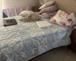 Bed with blue-and-white patterned bedding and assorted pillows.