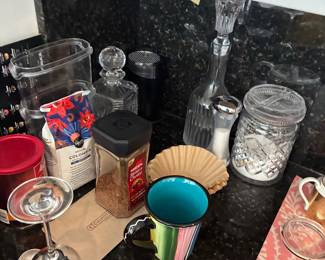 Assorted glass storage jars, containers, and kitchen accessories.