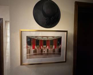 Framed colorful architectural artwork displayed beneath a black wall decoration.