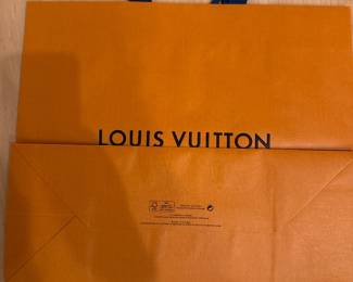 Orange Louis Vuitton-branded shopping bag; packaging shown.