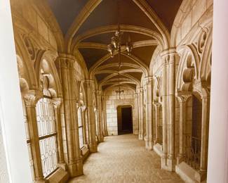 Framed architectural photograph of a vaulted corridor with decorative columns.