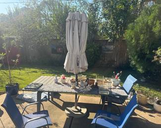 Outdoor patio dining table, chairs, and umbrella.
