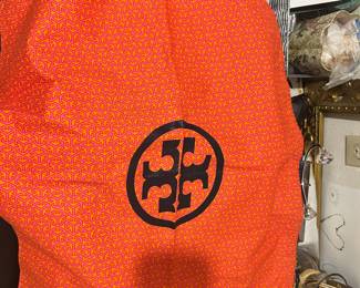 Orange Tory Burch-branded bag; packaging shown.